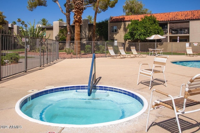 view of swimming pool with a community hot tub and a patio