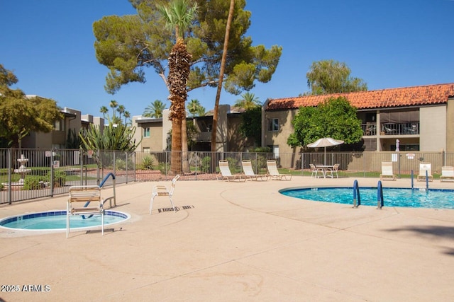 view of swimming pool featuring a community hot tub