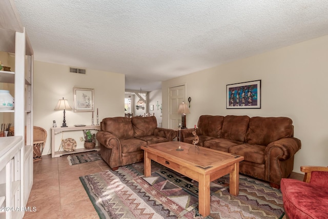 living room with light tile patterned flooring and a textured ceiling