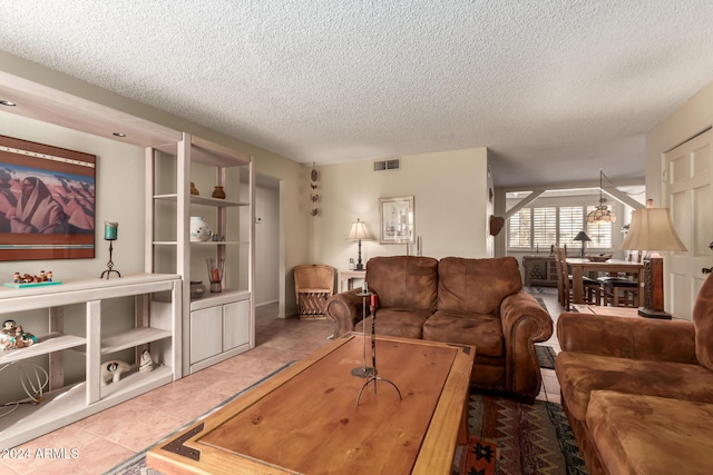 living room with a textured ceiling and tile patterned floors