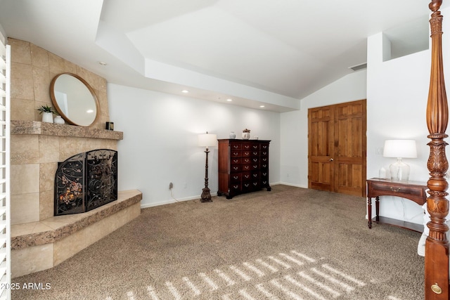 sitting room with carpet flooring, a fireplace, and vaulted ceiling