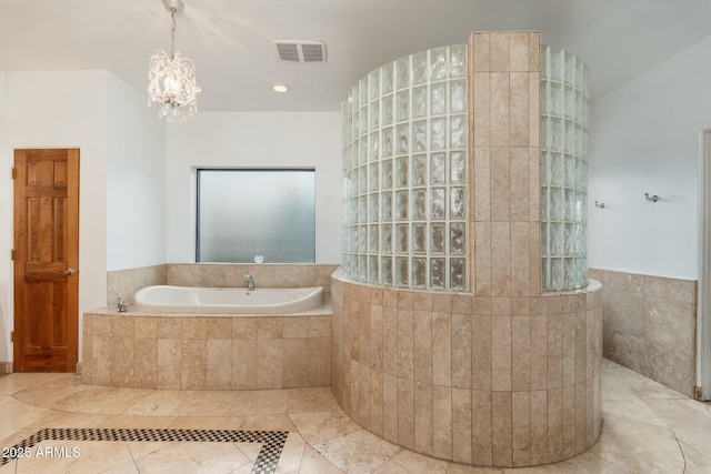 bathroom featuring separate shower and tub and an inviting chandelier