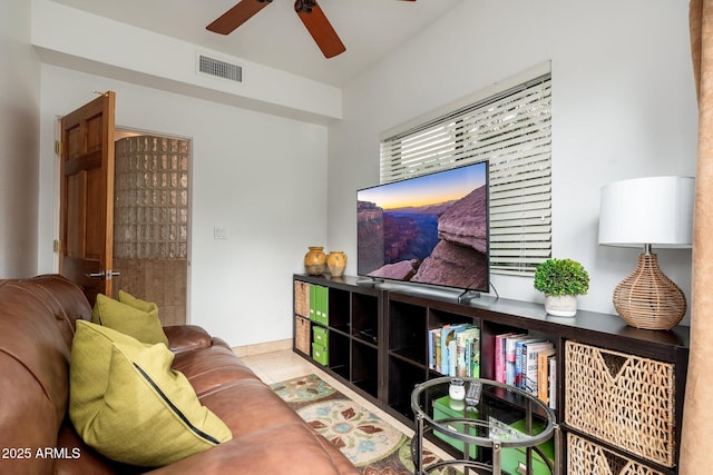 tiled living room featuring ceiling fan