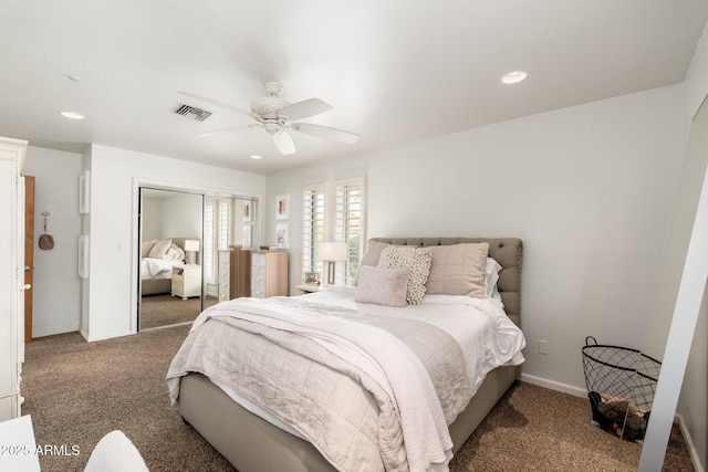 carpeted bedroom with ceiling fan and a closet