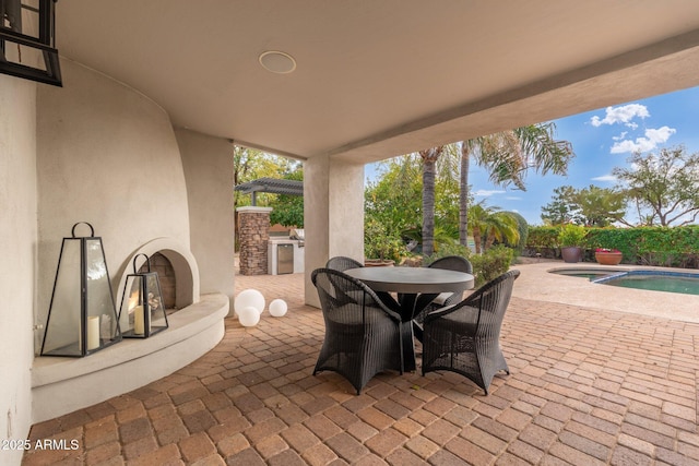 view of patio featuring a fenced in pool and an outdoor kitchen