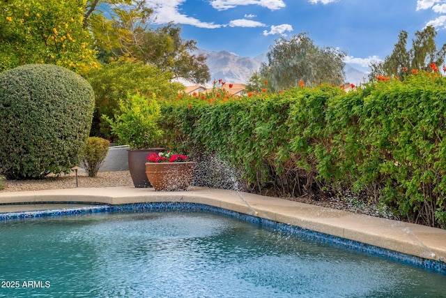 view of swimming pool with a mountain view