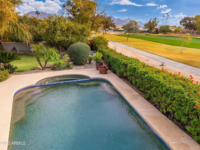 view of swimming pool with a mountain view and an in ground hot tub