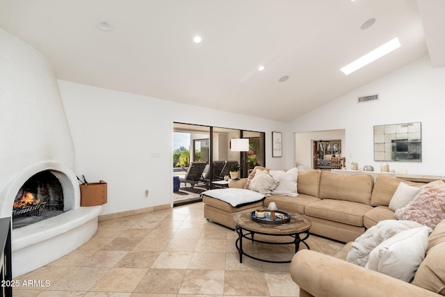 living room featuring a fireplace and high vaulted ceiling