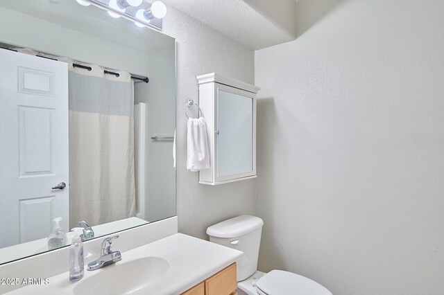 16631 E El Lago Blvd Unit 208, Fountain Hills, AZ 85268 - full bathroom with a textured wall, toilet, vanity, and a shower with shower curtain