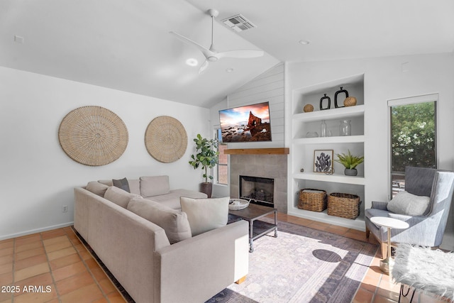 living room featuring built in features, lofted ceiling, a fireplace, baseboards, and a ceiling fan