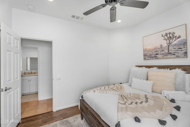 bedroom featuring visible vents, a ceiling fan, wood finished floors, recessed lighting, and a sink