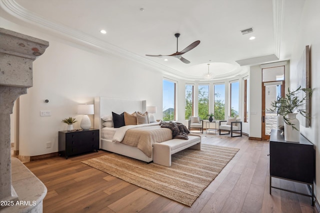 bedroom with recessed lighting, ornamental molding, light wood finished floors, baseboards, and visible vents