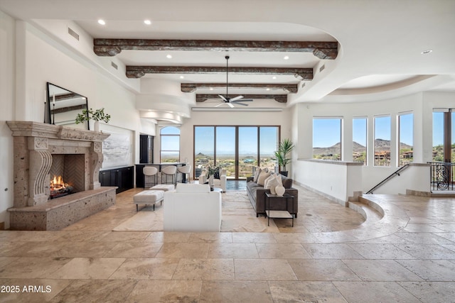 living area featuring recessed lighting, a ceiling fan, a premium fireplace, and stone tile flooring