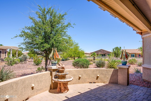 view of patio featuring fence and a pergola
