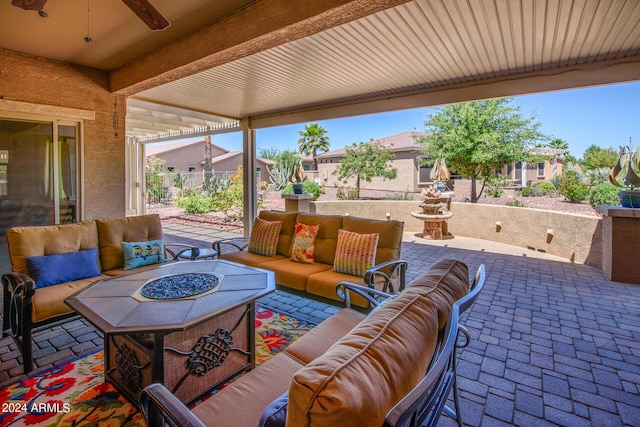 view of patio with fence, an outdoor hangout area, and a ceiling fan