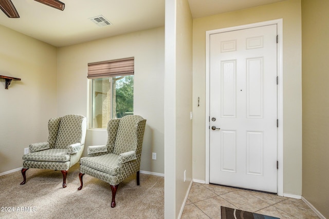 entrance foyer featuring baseboards, visible vents, and a ceiling fan
