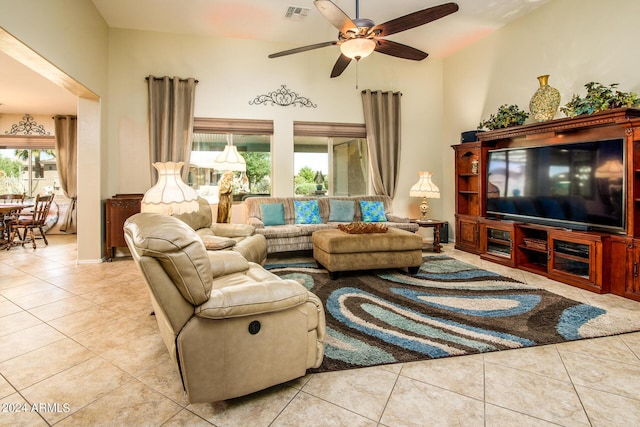 living room featuring lofted ceiling, visible vents, ceiling fan, and tile patterned floors