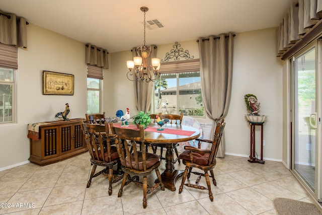 tiled dining area with a notable chandelier and a healthy amount of sunlight