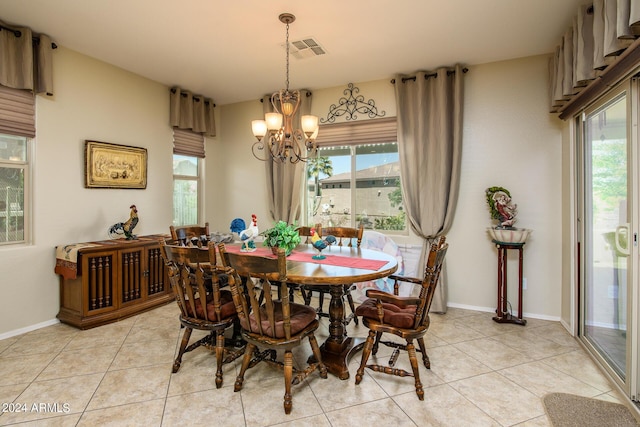 dining space featuring an inviting chandelier, light tile patterned floors, and a healthy amount of sunlight