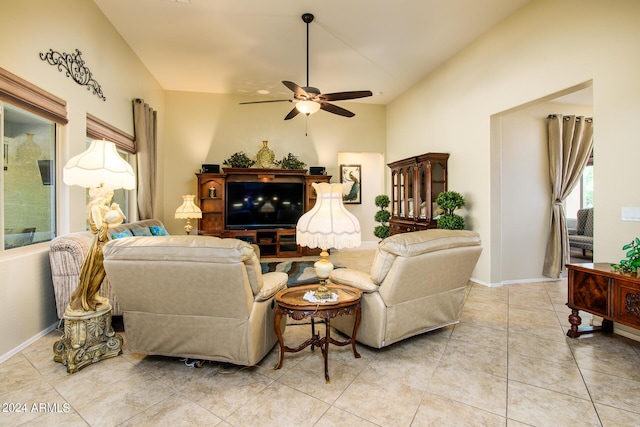 living room featuring light tile patterned flooring, ceiling fan, and baseboards