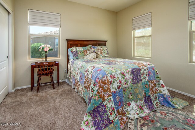 bedroom featuring light carpet and a closet