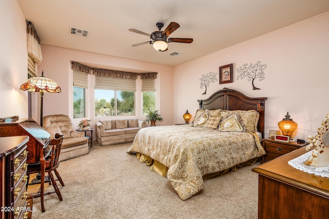 carpeted bedroom featuring visible vents and ceiling fan