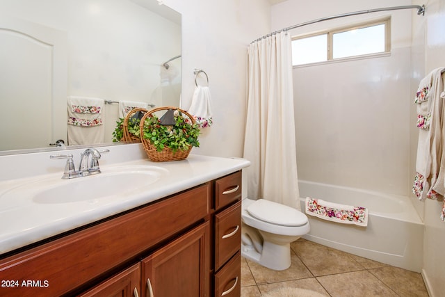 full bathroom with vanity, toilet, shower / bath combo with shower curtain, and tile patterned flooring