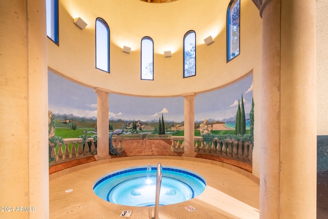 pool at dusk with a patio and an indoor in ground hot tub