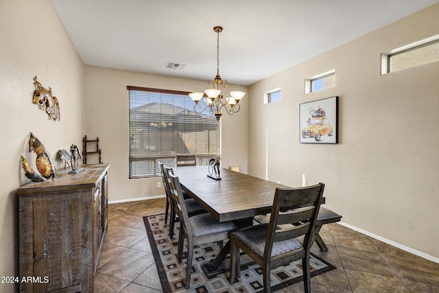 tiled dining room with a notable chandelier