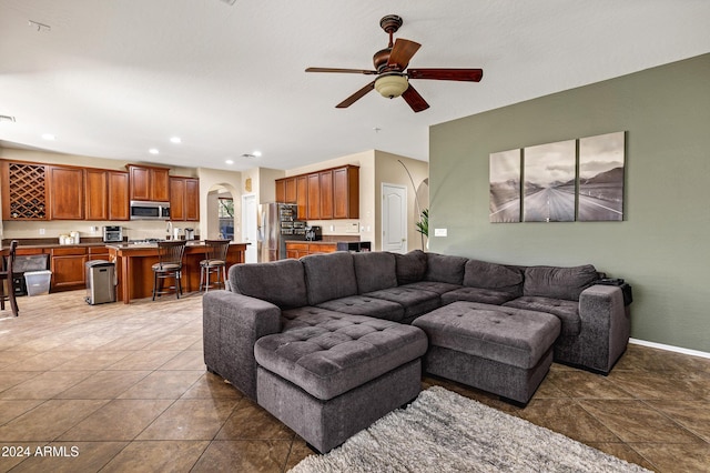 tiled living room featuring ceiling fan