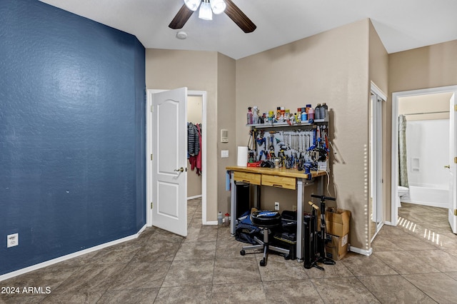 office with a workshop area, tile patterned floors, and ceiling fan