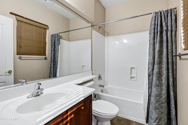 full bathroom with vanity, shower / bath combo, and toilet