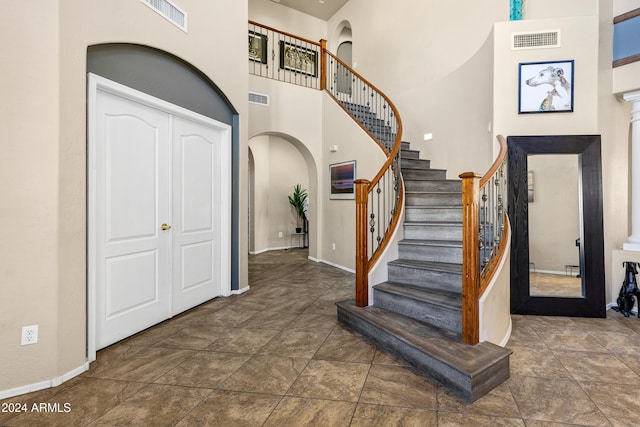 foyer featuring a towering ceiling