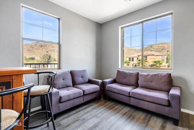 living room featuring a mountain view and dark hardwood / wood-style flooring