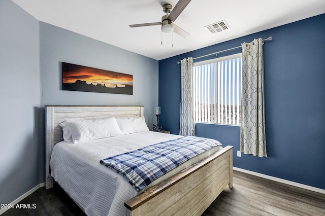 bedroom with dark hardwood / wood-style floors and ceiling fan