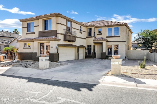 mediterranean / spanish home with a garage