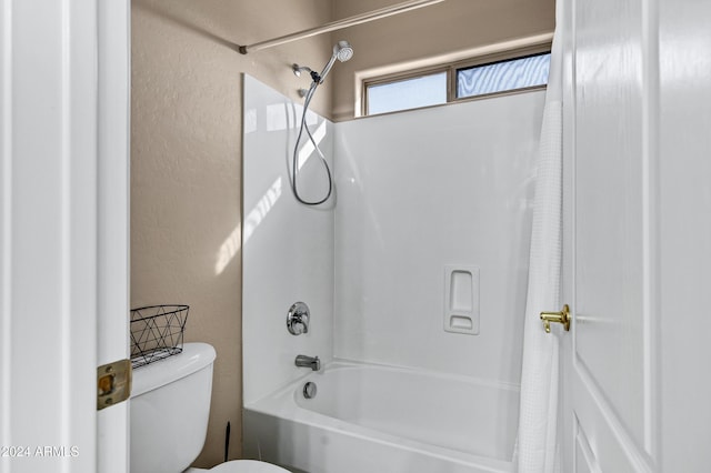 bathroom featuring shower / bath combination with curtain and toilet