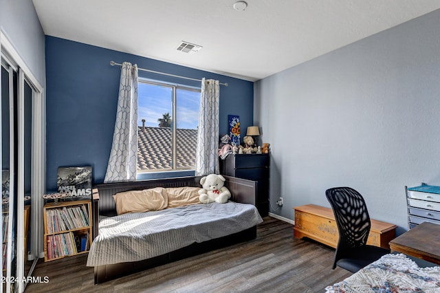 bedroom with hardwood / wood-style flooring and a closet