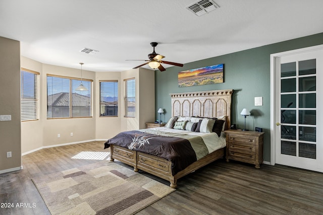 bedroom with ceiling fan and dark hardwood / wood-style flooring