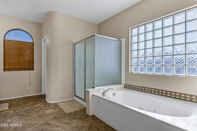 bathroom with separate shower and tub