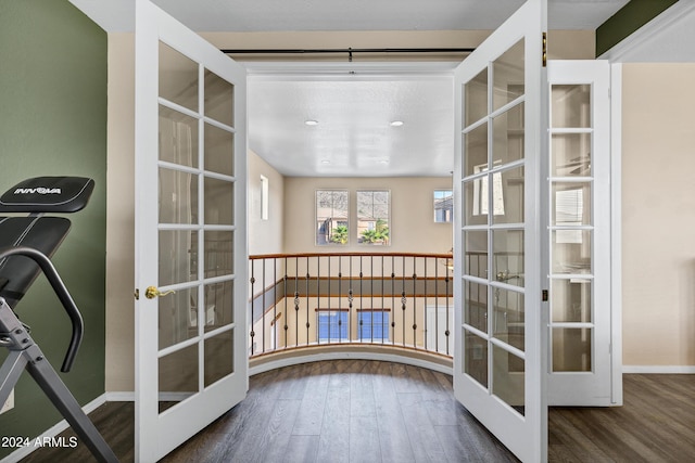 corridor featuring french doors and dark hardwood / wood-style floors