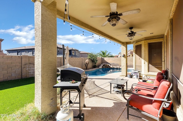 view of patio with ceiling fan, a grill, and a fenced in pool