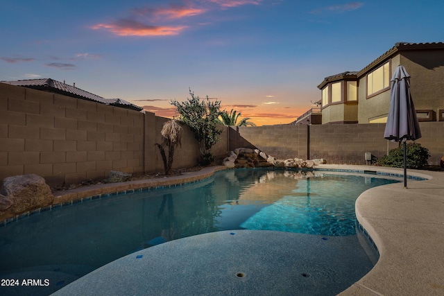 view of pool at dusk