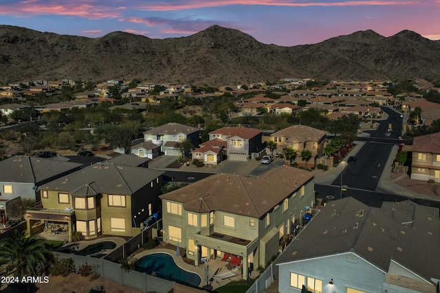 aerial view at dusk featuring a mountain view