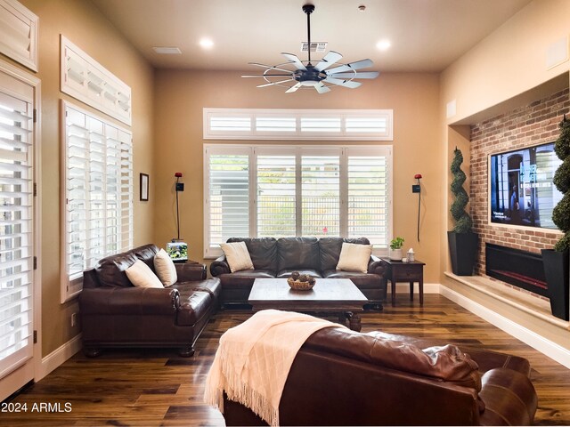 living room featuring dark hardwood / wood-style flooring, a wealth of natural light, and ceiling fan