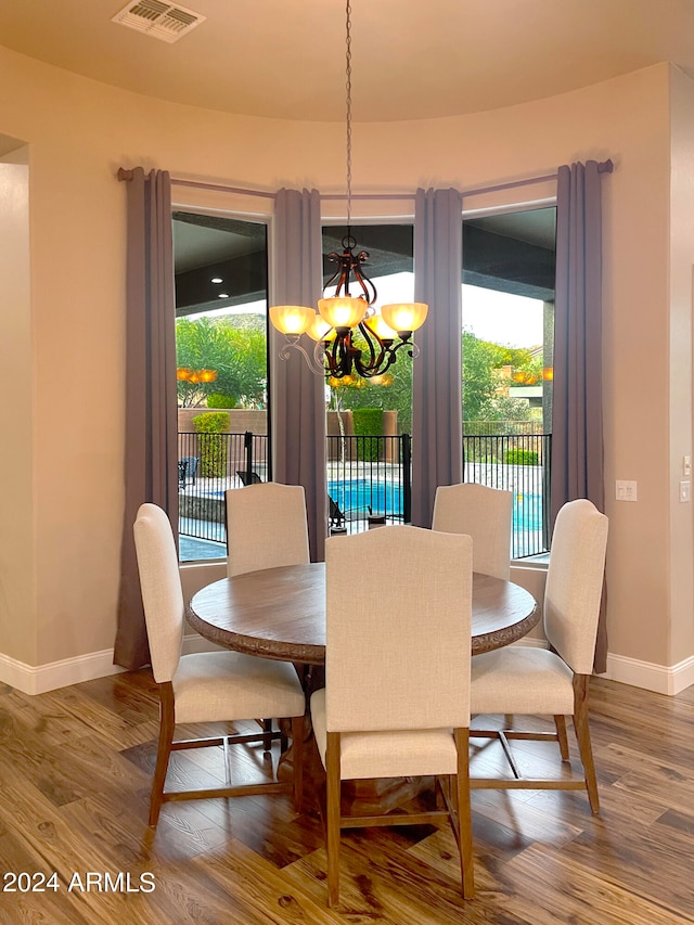 dining room featuring wood-type flooring and a chandelier