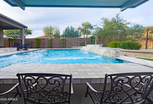 view of swimming pool featuring a patio area and pool water feature