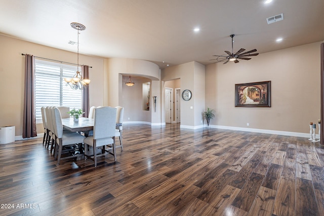 dining room with dark wood-type flooring and ceiling fan with notable chandelier