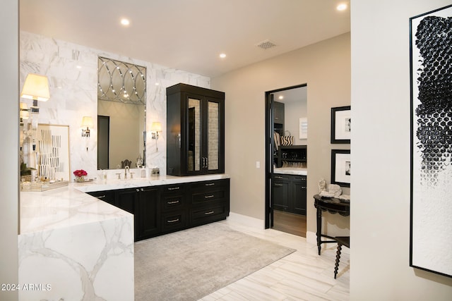 bathroom featuring wood-type flooring and large vanity