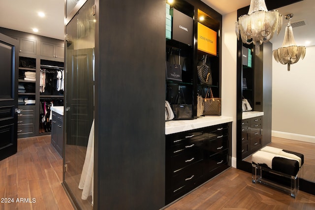 spacious closet featuring a notable chandelier